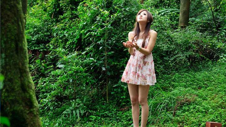 Girl In Forest Looking Up And Catching Somthing